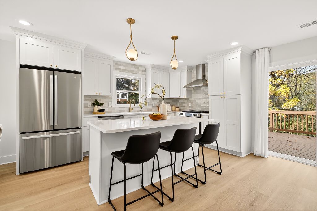 Brookdale renovation kitchen with brass pendants and warm finishes